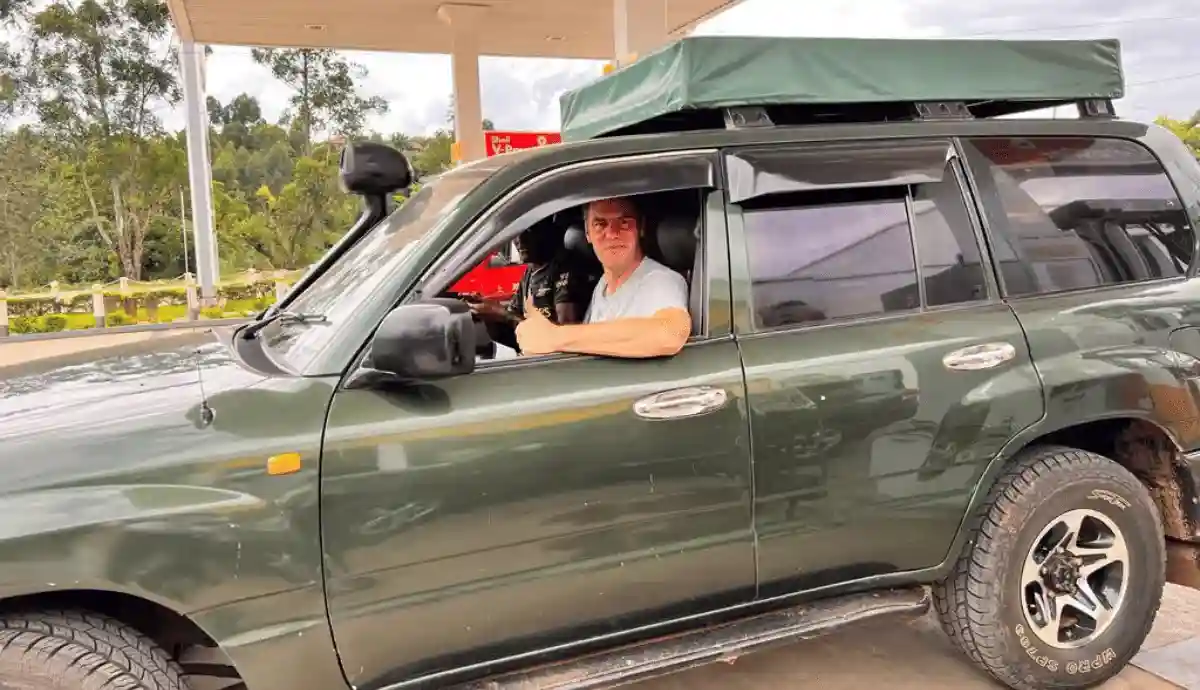 A 4x4 Landcruiser GX with a driver and rooftop tent heading to Queen Elizabeth National Park in Uganda