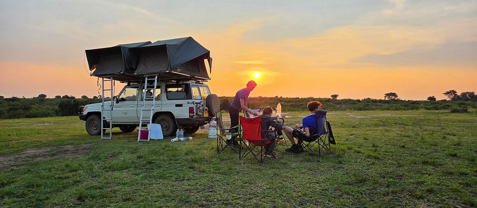 A family enjoying their self made breakfast on a camping safari